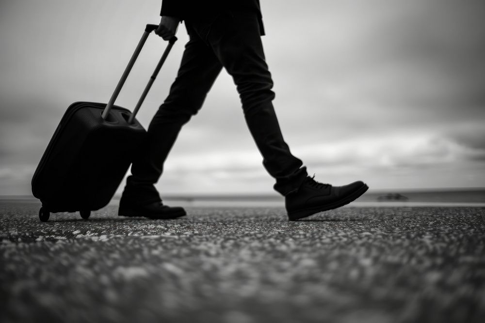 Guy traveling clothing footwear suitcase.
