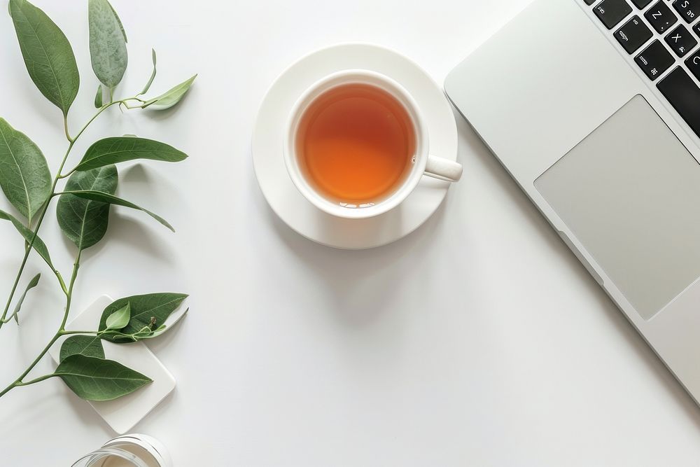 Laptop on table with tea cup electronics beverage computer.