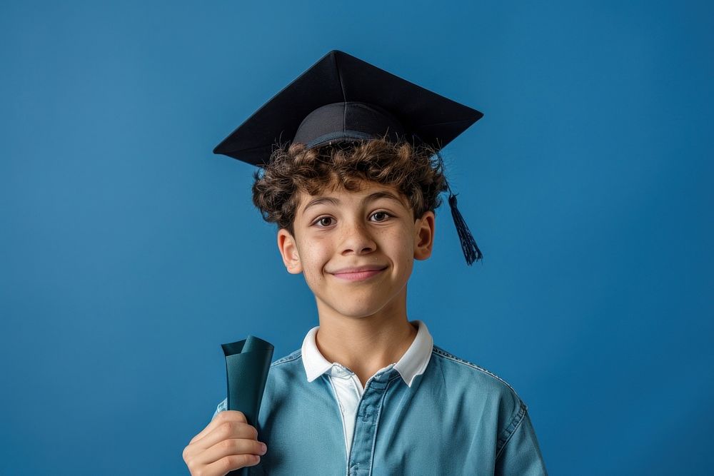 Student boy holding graduation hat clothing apparel person.