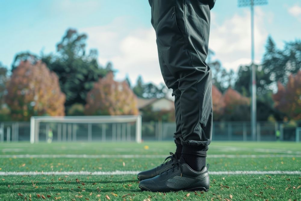 Soccer footwear standing grass.