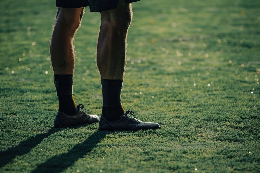 Soccer field footwear standing.