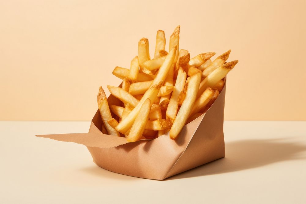 Close up on pale french fries in a paper pouch food freshness ketchup.