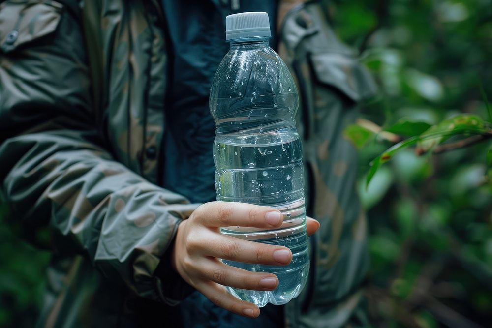 Close up of person holding water bottle drink adult refreshment.