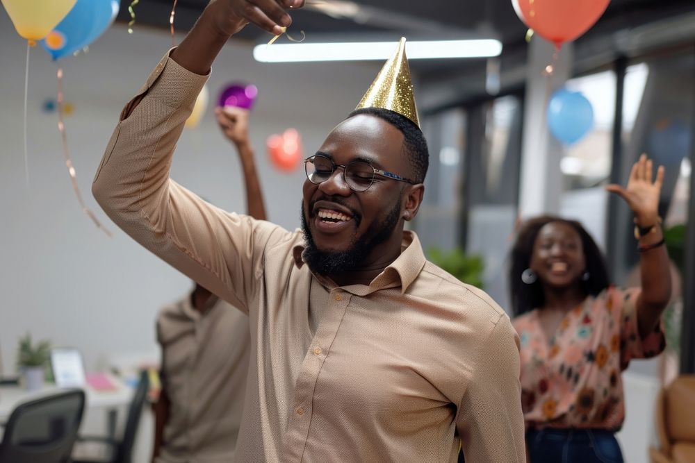 African businessman dancing birthday party hat celebrating accessories.