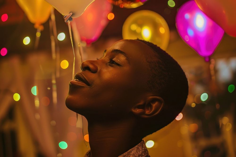 African teenager celebrating birthday party night lighting balloon person.