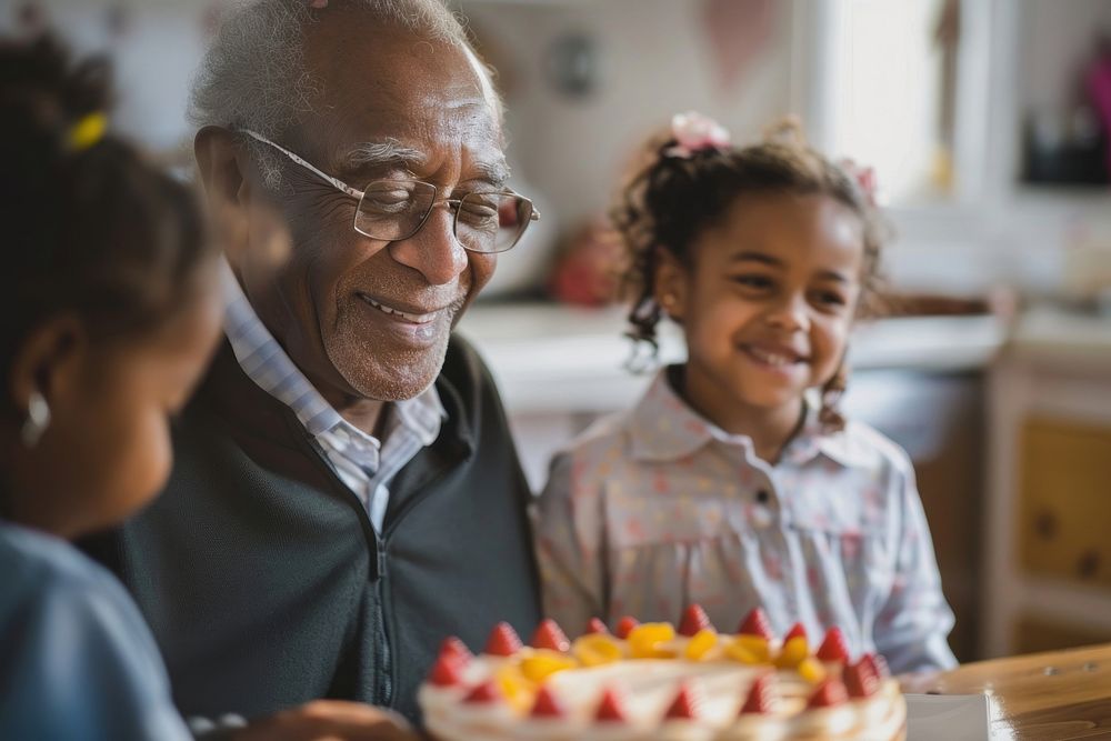 African Grandfather watching Hispanic girl eating birthday cake accessories accessory dessert.