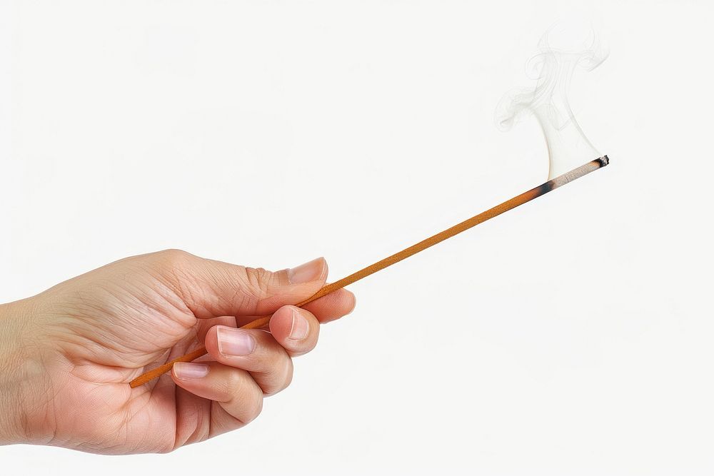 Hand holding incense stick smoke pipe.