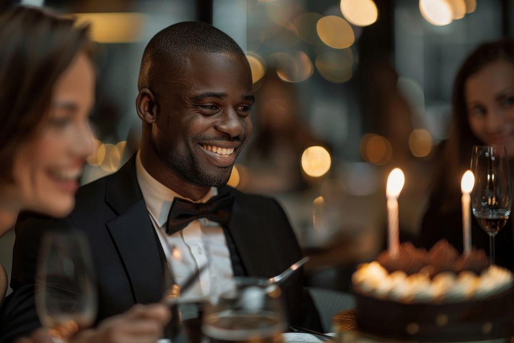 African man in suit impressed with birthday cake happy accessories bridegroom.