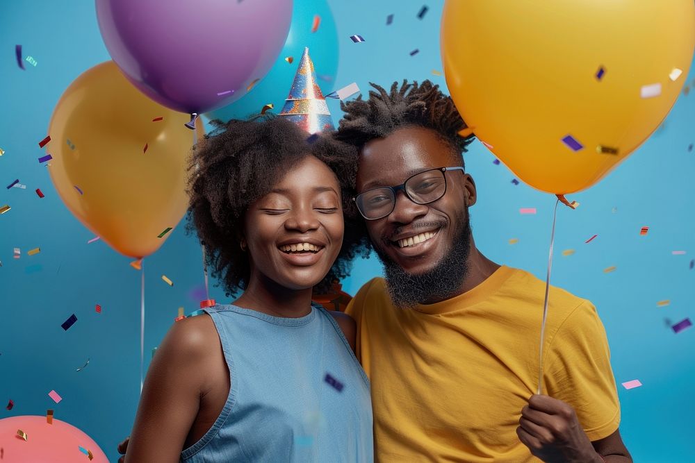 Couple African holding balloons happy party hat.