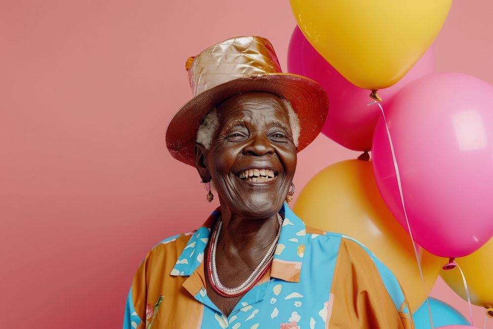 Lovely elderly African holding balloons happy photo hat.