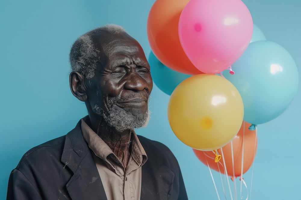 Lovely elderly African man holding balloons happy person human.
