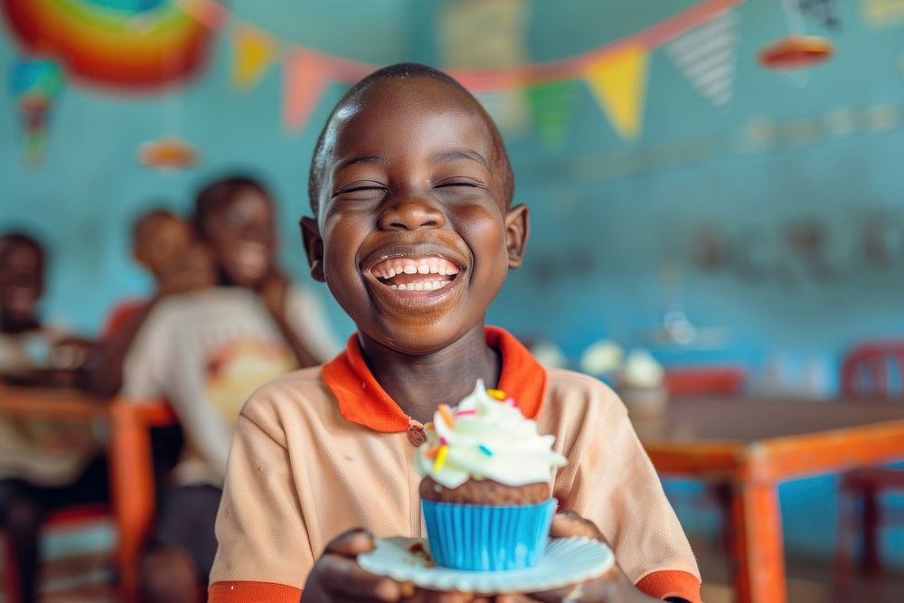 Laughing African kid celebrating his birthday people person human.