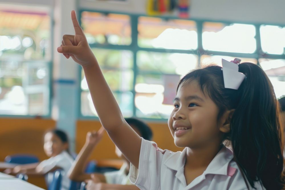 South east Asian girl hand up happy kid student.
