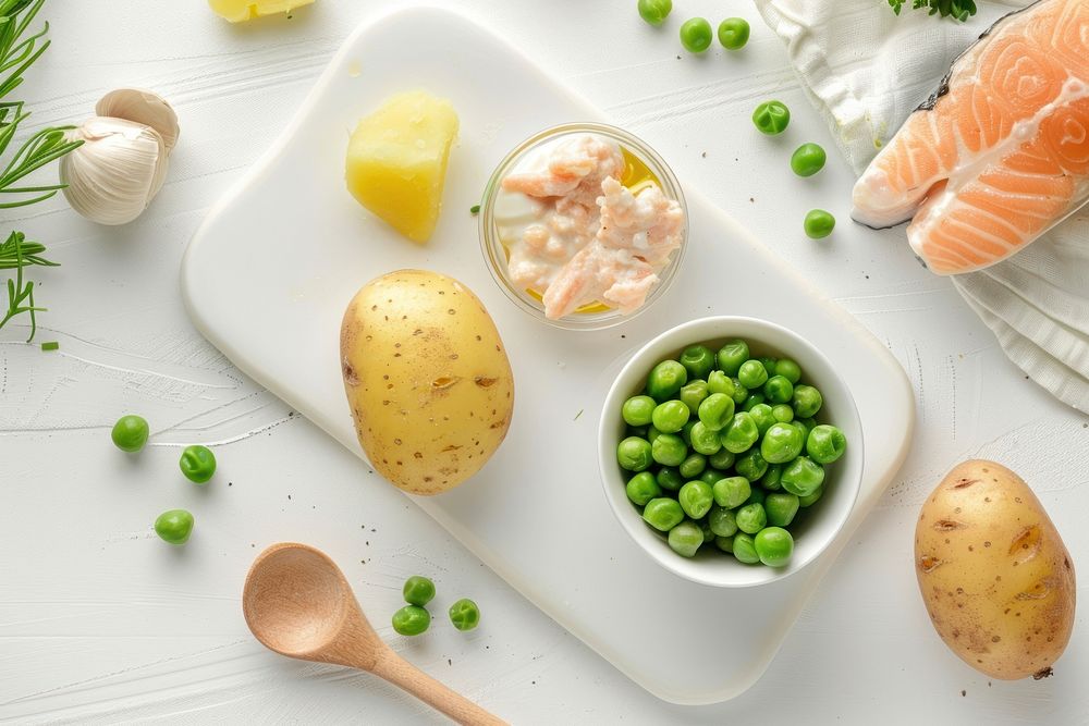 A white baby board vegetable spoon food.