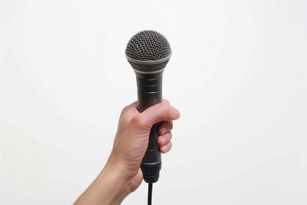 Hand holding microphone electrical device.