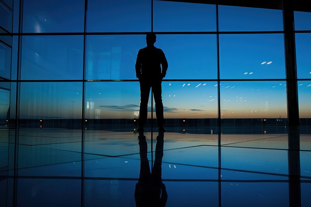 Silhouette guy corporate travel building background standing lighting airport.