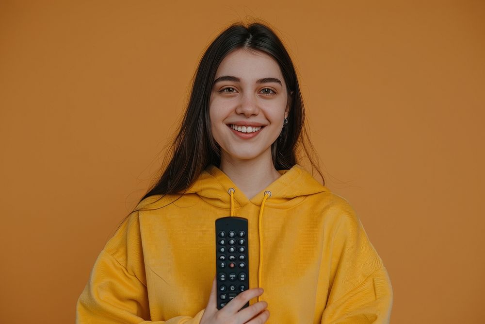 Happy woman holding a remote control photo electronics photography.