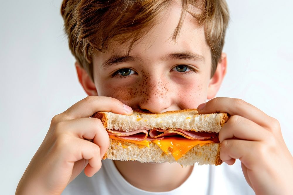 Teenage boy eating ham cheese sandwich person biting human.
