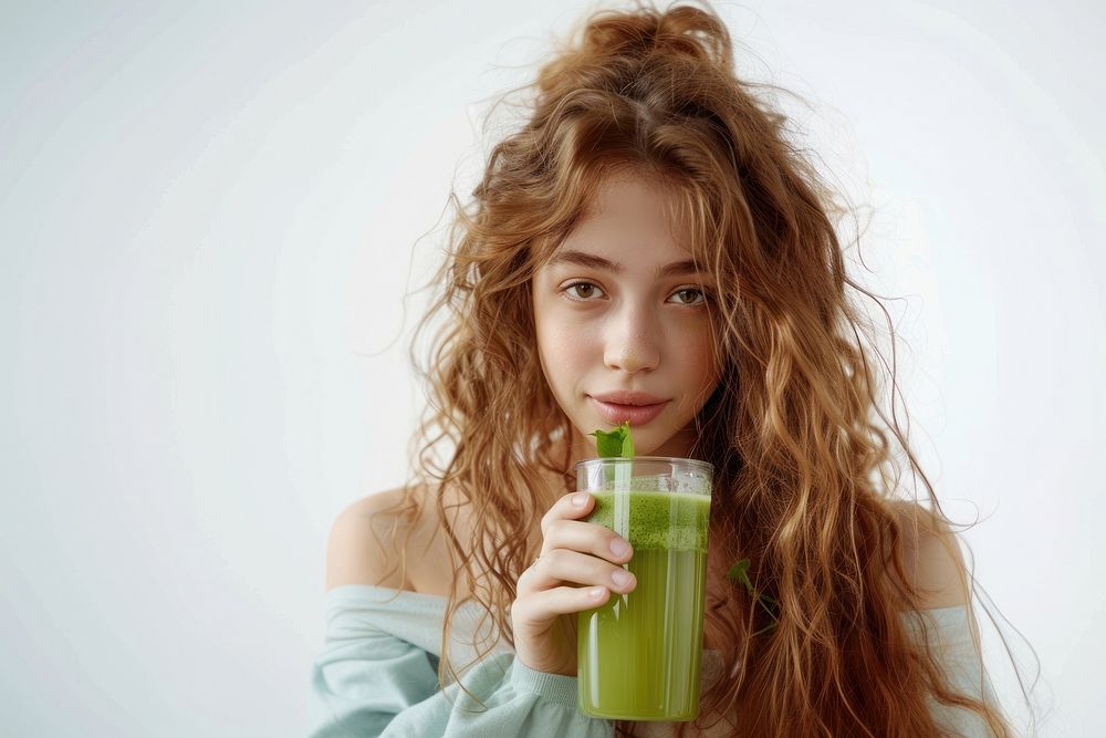 Teenage girl drinking green juice photo photography beverage.