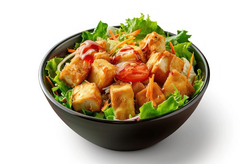 A salad bowl with tofu and salad dressing lunch food meal.
