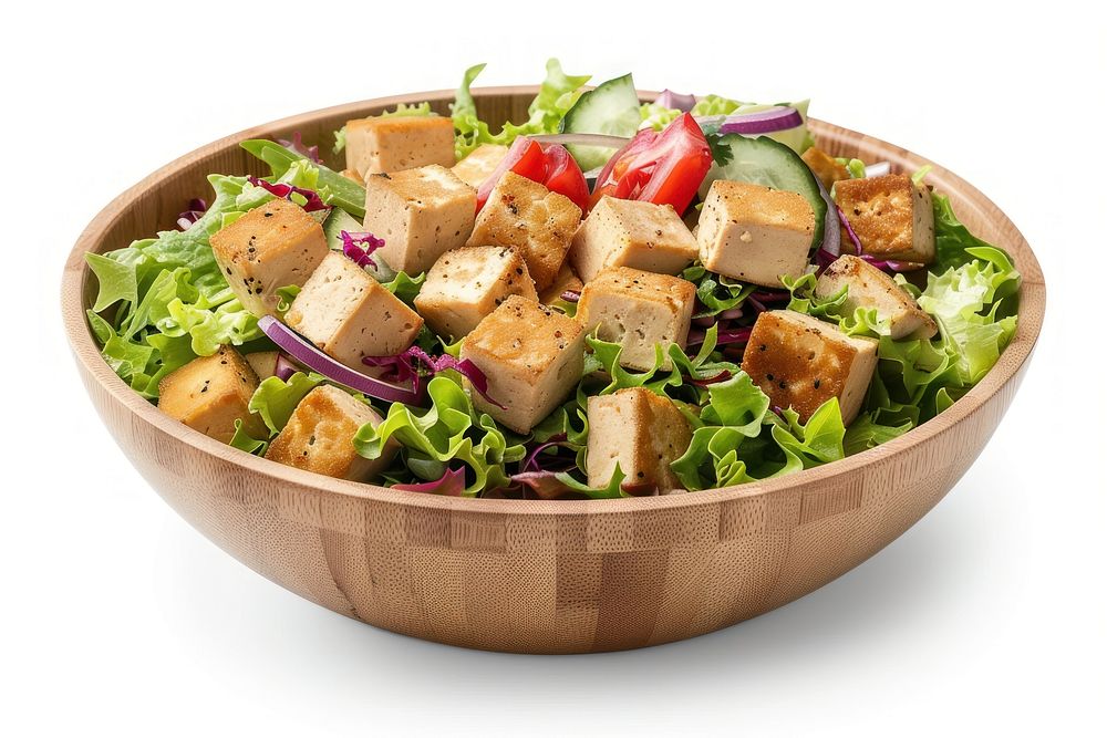 A salad bowl with tofu and salad dressing lunch bread food.