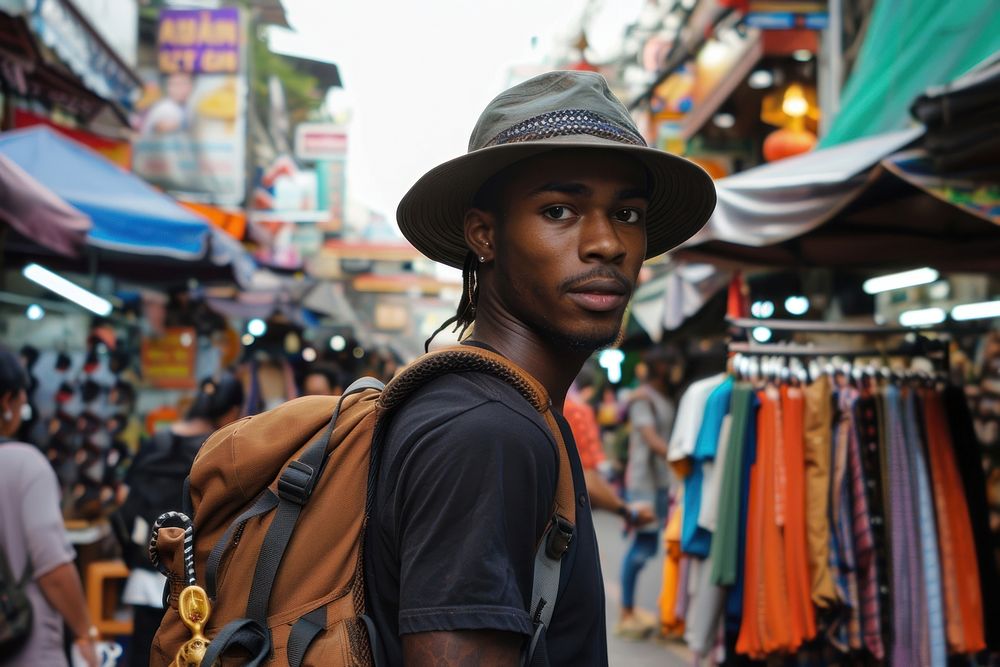 Young Afican traveling backpacker photography market road.