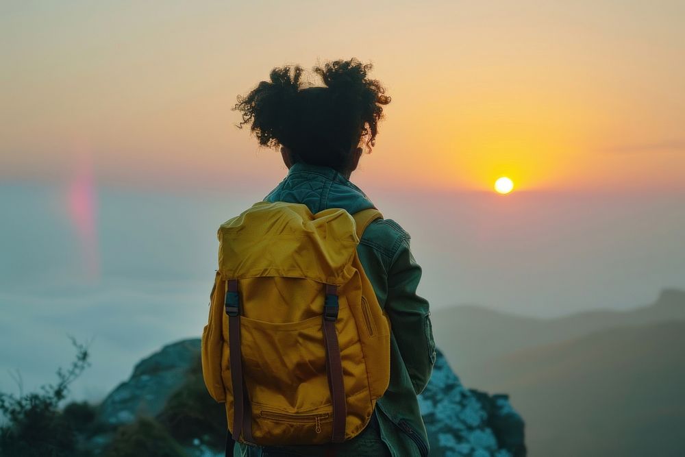 African young girl with backpack backpacking astronomy outdoors.