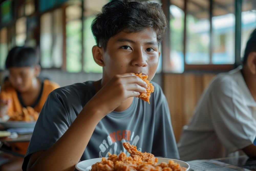 Filipino teenage eating food clothing.