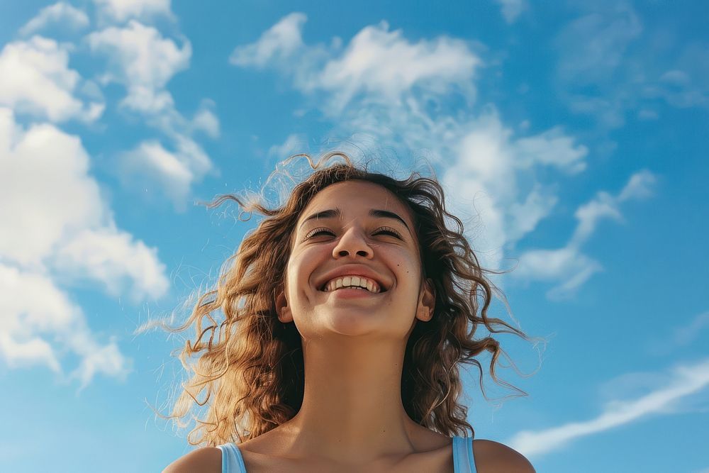 Woman smiling sky laughing outdoors.