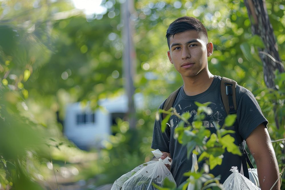 A young Latino environmentalist leading a community cleanup campaign head accessories accessory.