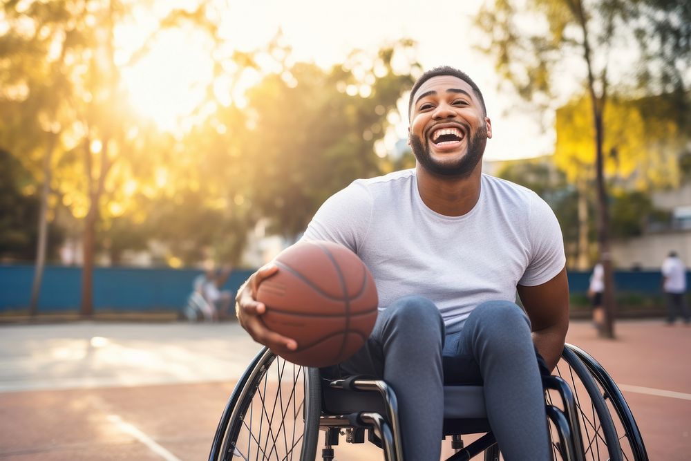 A happy man disability ridding in wheelchair basketball laughing sitting.
