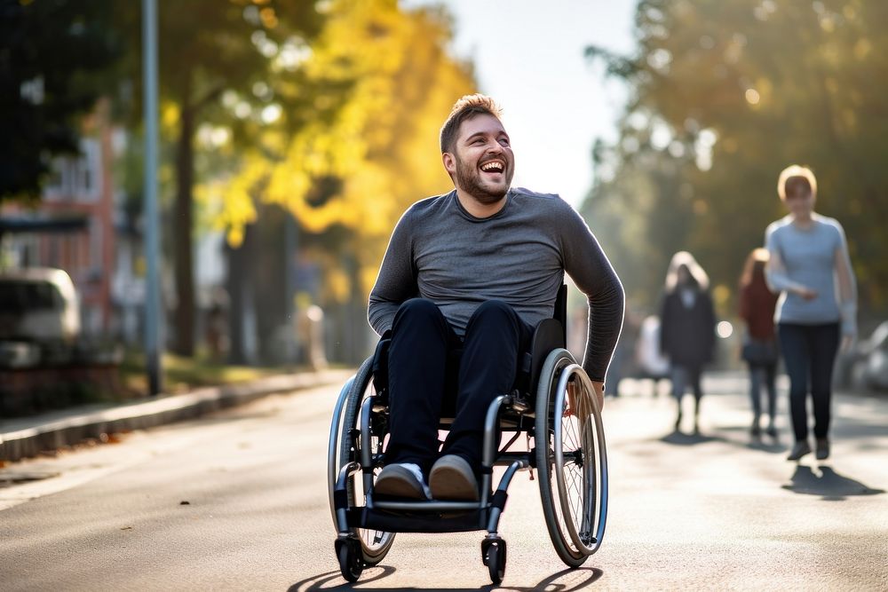 A happy man disability ridding in wheelchair transportation automobile clothing.