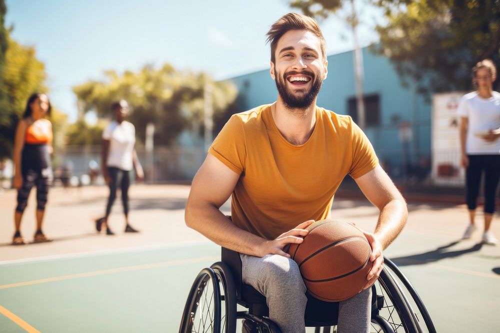 A happy man disability ridding in wheelchair basketball playing basketball laughing.