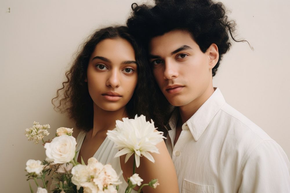 Young diversity couple wearing a minimal wedding dress photography portrait blossom.