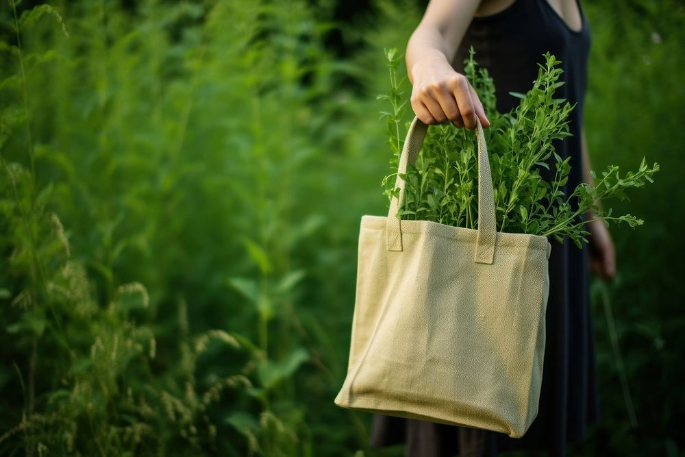 Woman holding jute bag outdoors nature accessories.