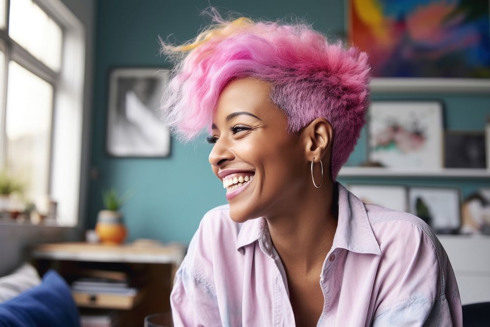 A black woman with white casual home attire and bright hair color smiling female person adult.