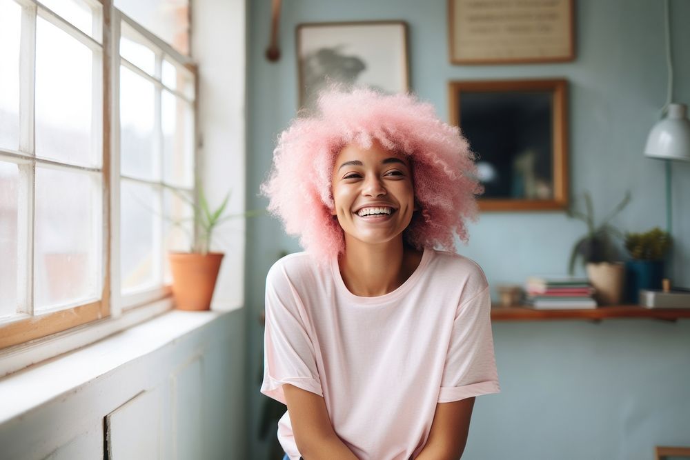 A black woman with white casual home attire and bright hair color smiling laughing person female.