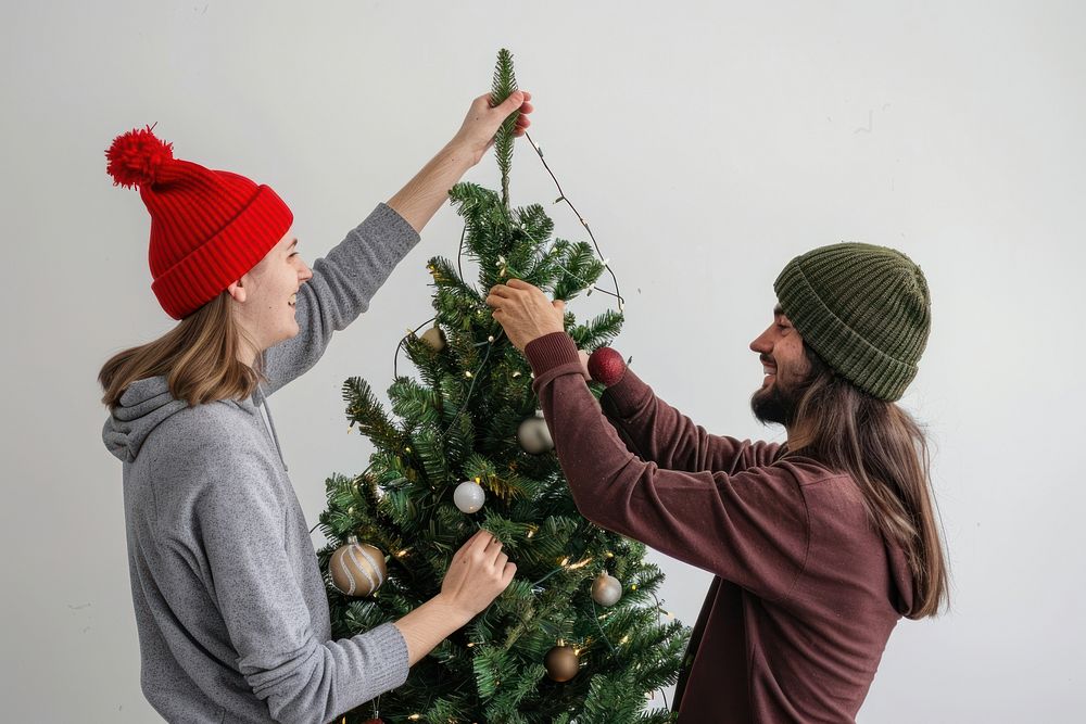 Happy man decorating christmas tree with girlfriend togetherness anticipation celebration.