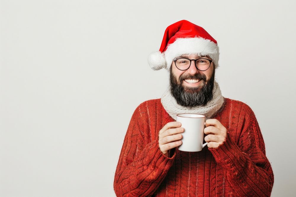 Happy man in xmas costume drinking hot chocolate christmas glasses cup.