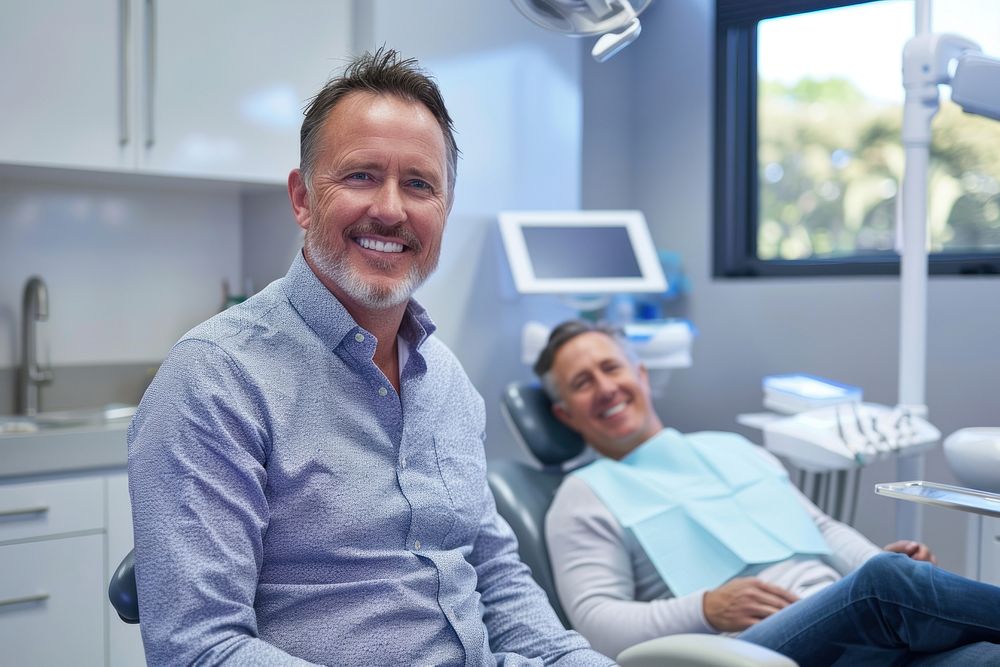 Man smiling with white teeth sitting dentist adult.