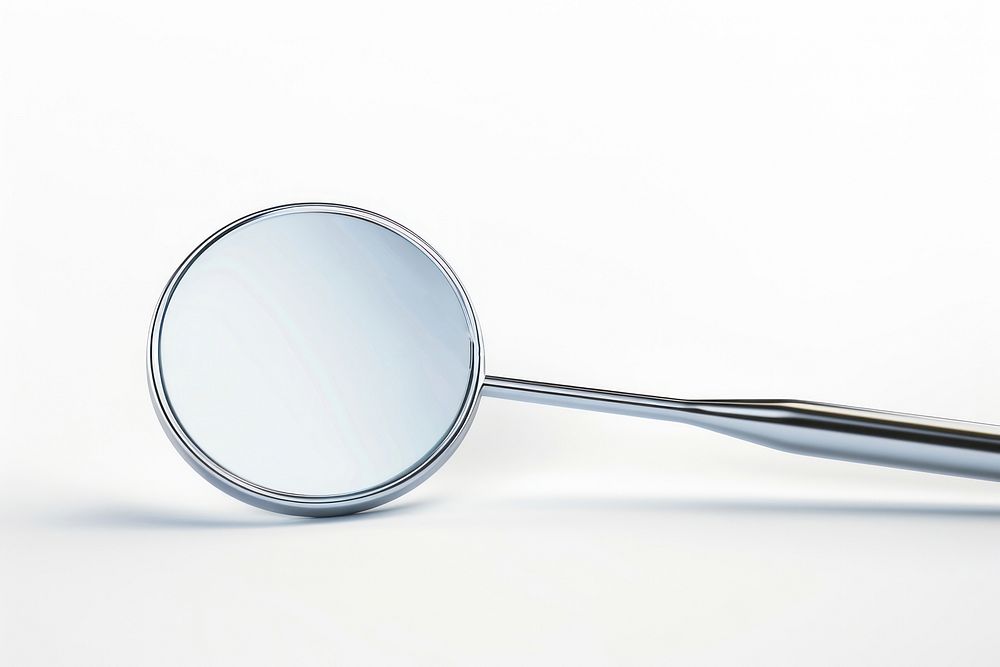 Dental mirror and probe white background reflection magnifying.