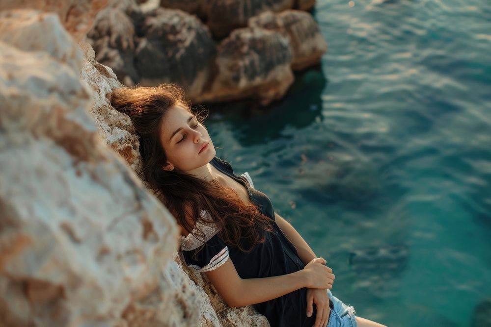 Young women Lying rock outdoors sea.