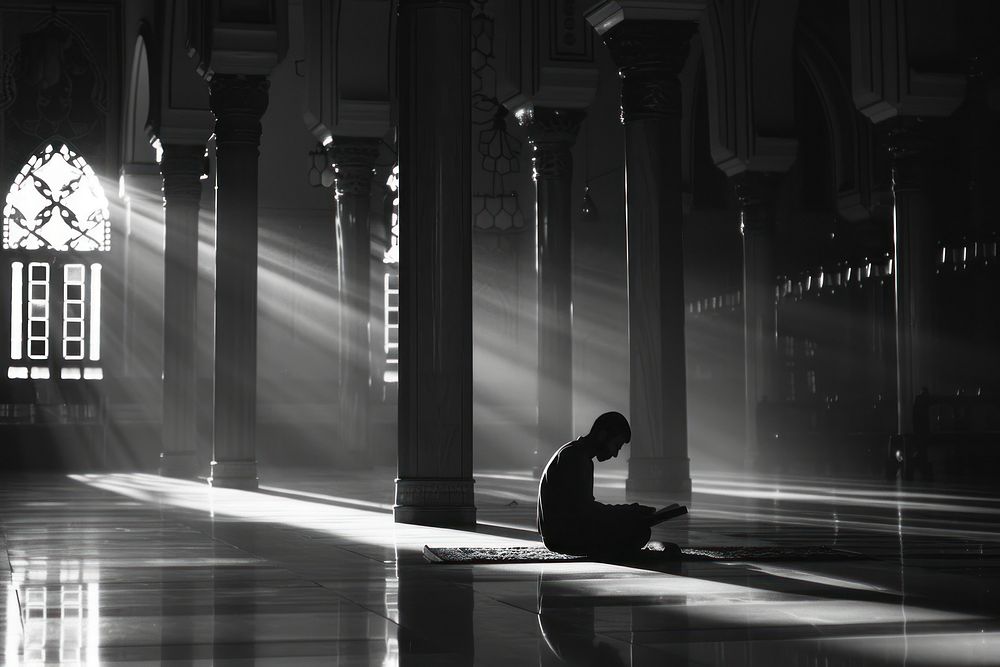 Muslim reciting Quran lighting flooring worship.