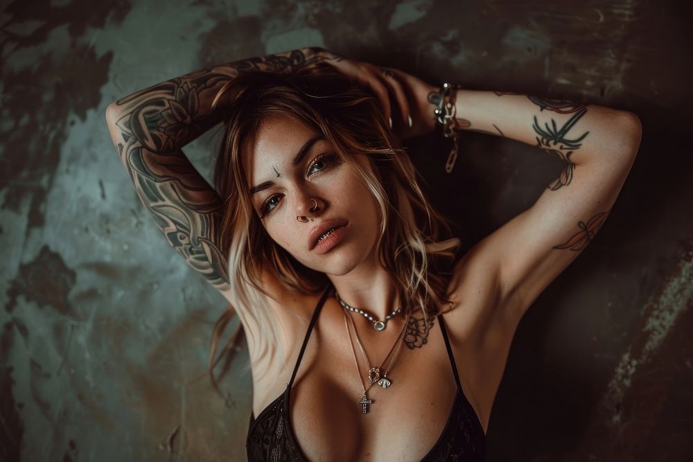 Edgy and rebellious clothing models with tattoos necklace portrait.