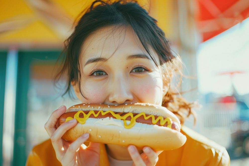 Woman enjoying a hotdog eating food hamburger.