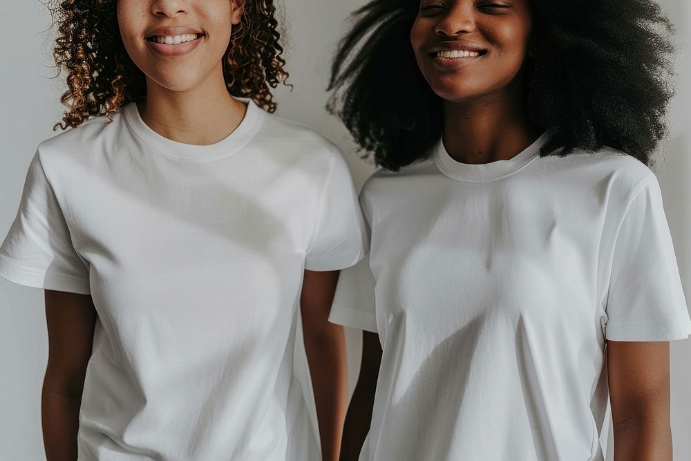 Two women posing for a t-shirt merch drop photoshoot sleeve white togetherness.