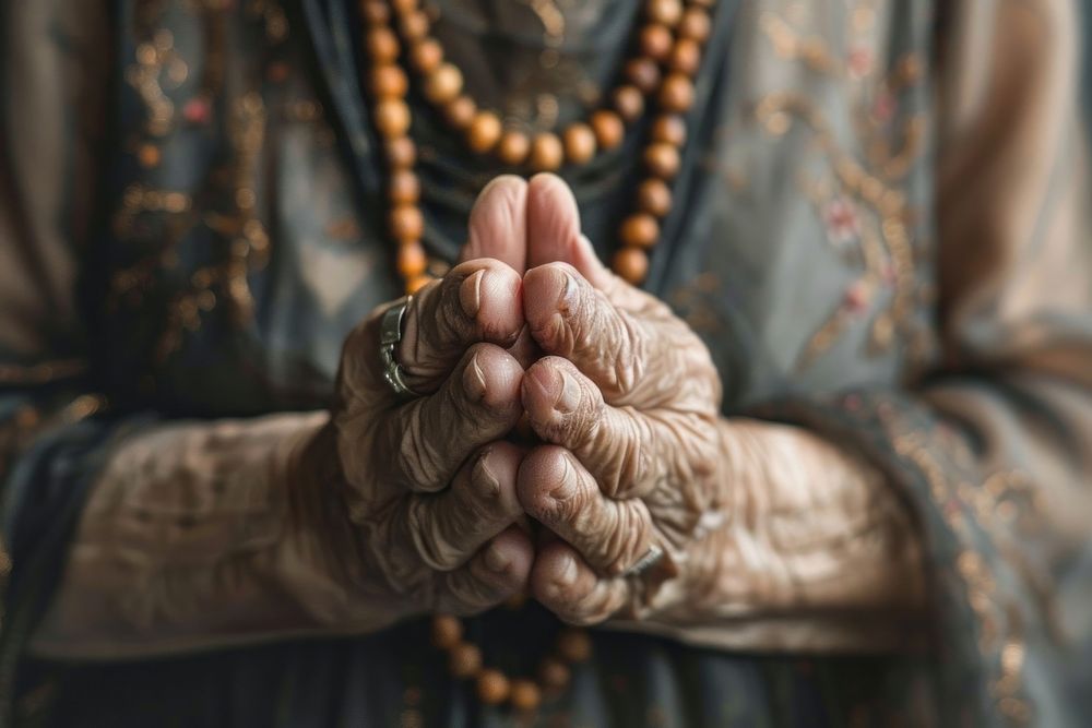 Old woman prayer rosary hand bead.