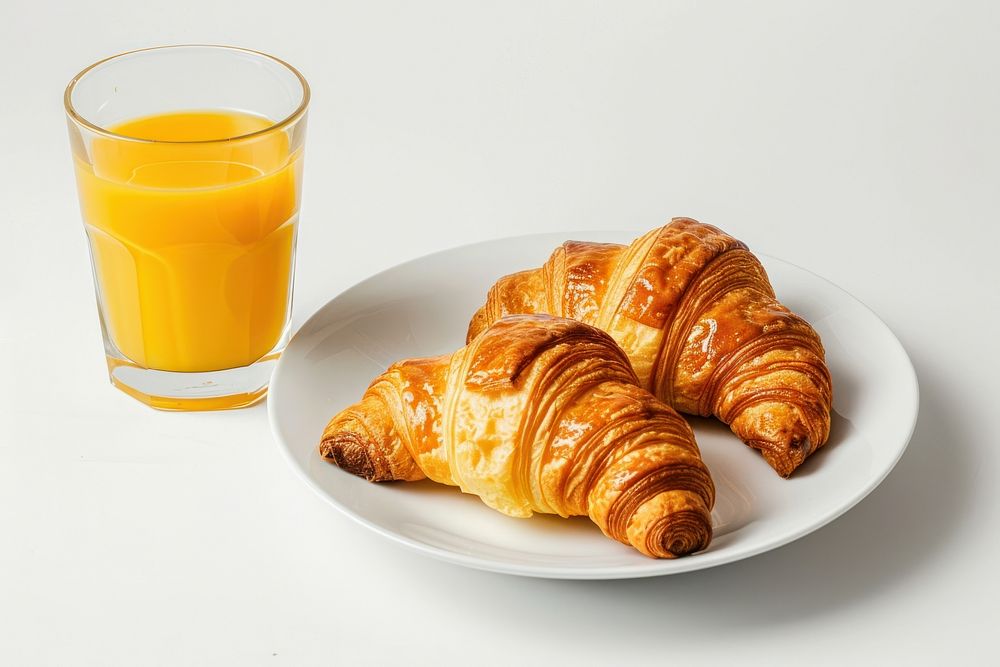 Breakfast with croissants juice bread drink.