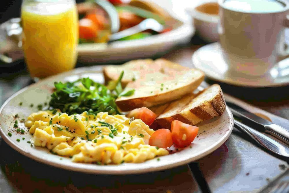 Breakfast with scrambled eggs brunch juice plate.