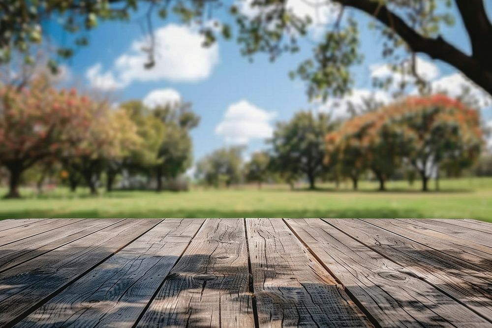 Wooden table background on a blur farm wood landscape outdoors.